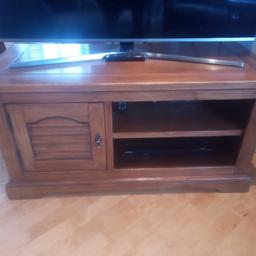 TV cabinet. Good quality pine, stained to look like oak. 1.2m x 55cm. Shown with 49" tv on (tv not included). Matching side dresser and extendable dining table and chairs also available.