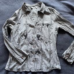 M&S Per Una Womens Shirt Size 12. Dark Blue/Grey. Button up open neck. Beaded and Sequin detail on front and top back. Printed flower detail. Crinkle effect. One button on cuffs. Light 100% cotton material.