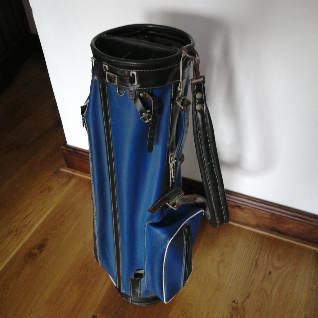 Blue leatherette type golf bag with multi compartments, shoulder strap and club head cover. In reasonable condition with plenty of life leleft in it