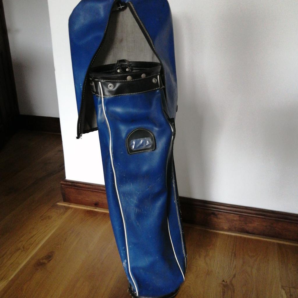 Blue leatherette type golf bag with multi compartments, shoulder strap and club head cover. In reasonable condition with plenty of life leleft in it