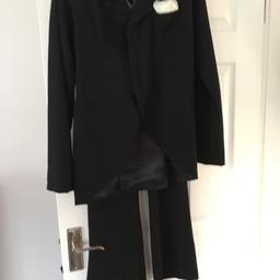 Black jacket with tails and black trousers.
Size - Trousers length 43” inside leg 32” waist 30”
Jacket length 28” bust 34” arm 24”