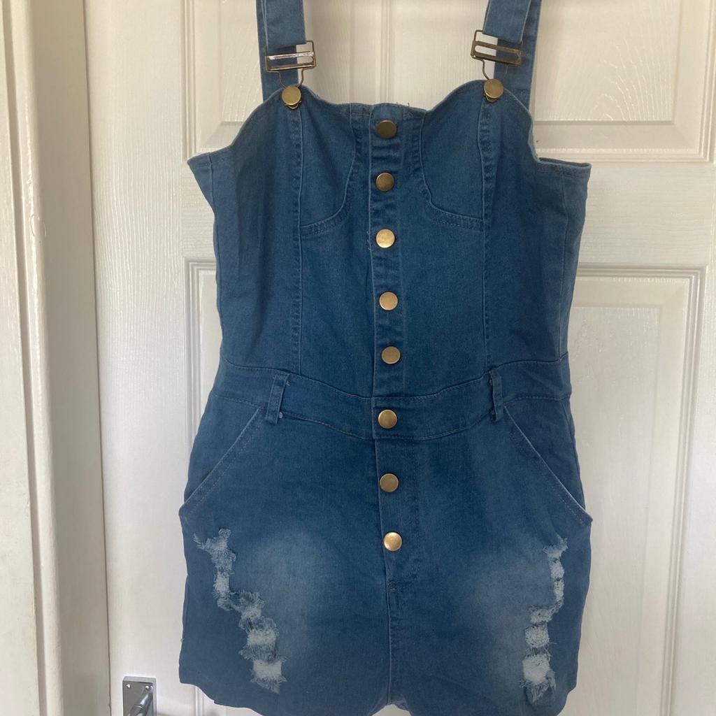 Blue denim style dungeree style buttoned jump suit ripped front style