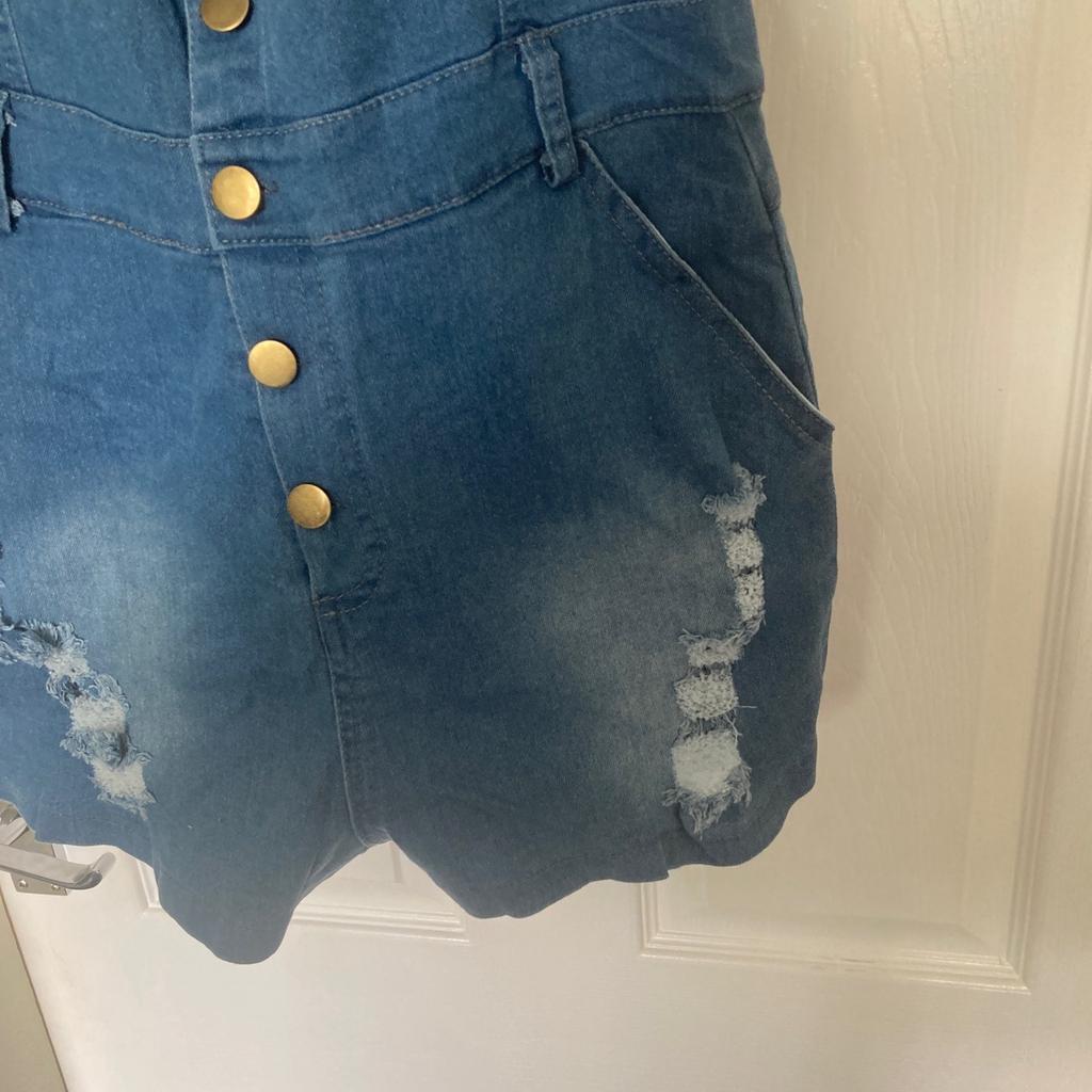 Blue denim style dungeree style buttoned jump suit ripped front style