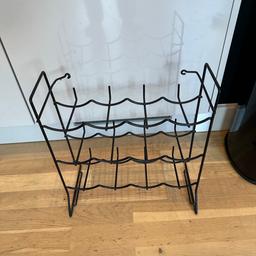 Black metal 12 Bottle wine rack in good used condition. Perfect to store bottles on and has no flaws. Collection Chelmsford or local delivery possible