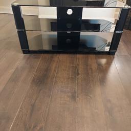 large glass T V stand like new no scratches or marks on it