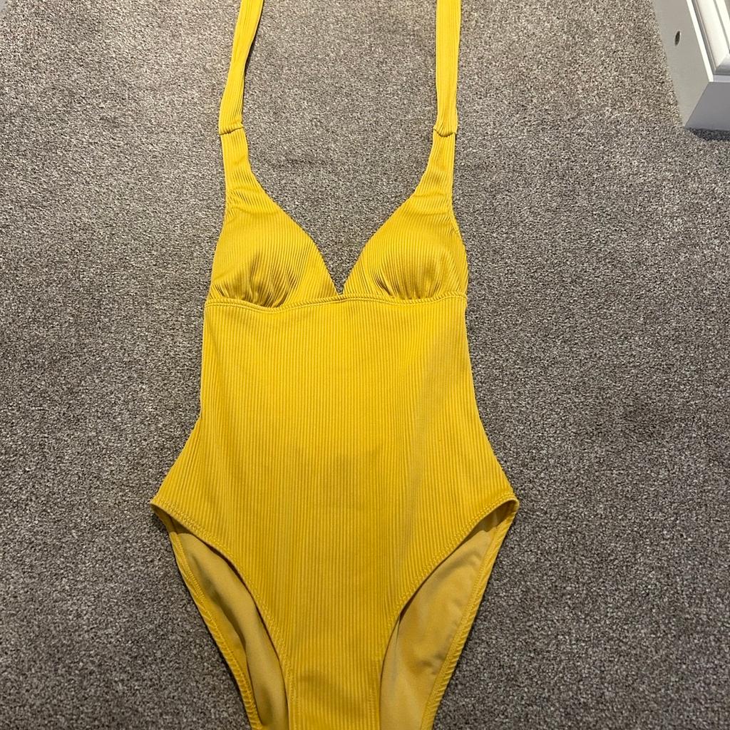 Only worn once
Excellent clean condition- like new
Halter neck textured swimsuit
Removable padded inserts in the bra cup
Mustard coloured
Listed on multiple sites
From a smoke free pet free home