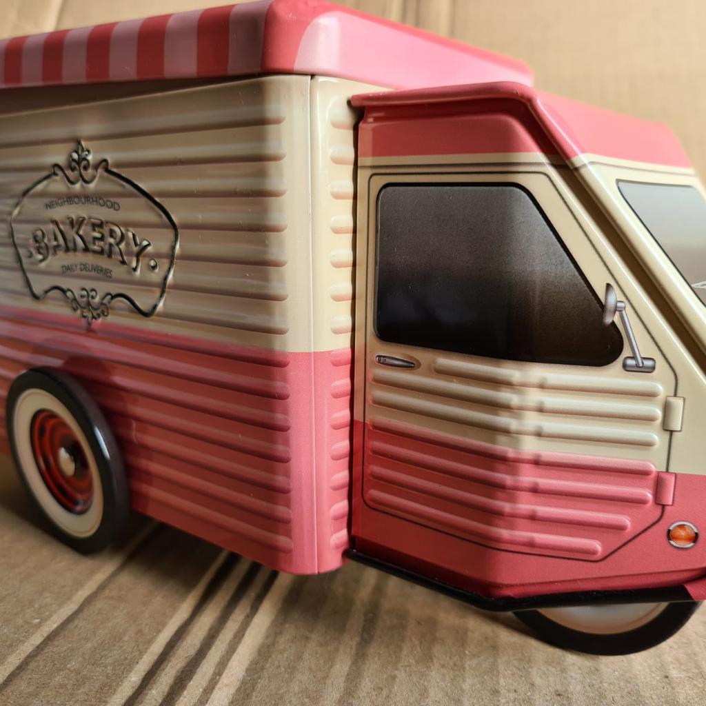 A pair of biscuit tins with a tuk tuk design. Wheels spins & make a unique desk piece or display use.