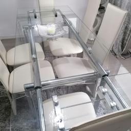 6 seater dining table set with cream/offwhite leather chairs and extending glasstop table. Can deliver local for fuel.