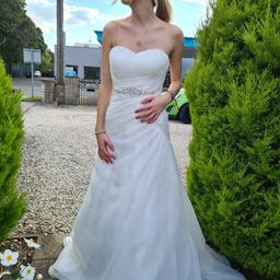 This stunning wedding dress in UK size 8 is perfect for the big day. The ivory colour is a classic and elegant choice, while the size ensures a comfortable fit. The dress is ideal for any formal occasion, especially weddings. 

The intricate details on the dress make it a true work of art. The dress is in excellent condition and has been well-maintained. It is sure to create a lasting impression on anyone who sees it.

Gorgeous fit, lace up back for comfort and better fit, fitted with sweetheart neckline, moulded cups, bejeweled under bust, built in underskirt for shape, and train, this has been worn and is in lovely condition, there are some marks and small pulls in the train as this has been worn for a whole day, they don't affect how gorgeous the dress looks as seen in the photos and would be on the floor anyway