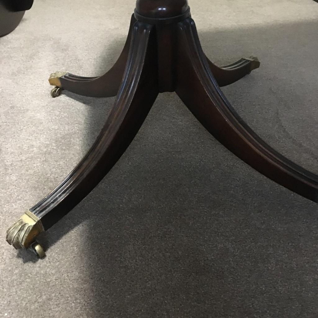 Oval mahogany dining table with tripod stand and brass casters , the top has 2 drop leaves, in fairly good condition apart from a scratch on the top , selling cheap to make space .