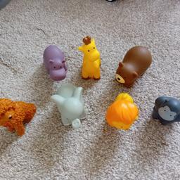 Selection of toy animals includes gorilla, hippo, giraffe, brown bear, lion, elephant and a toy waffle dog.