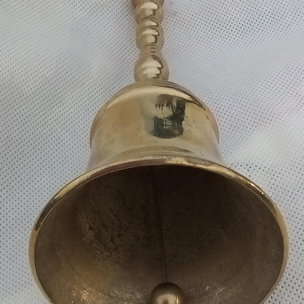 A wee bell with main body made of brass as well as the handle. Makes a very good sound that carries, as sadly can't post sound here.

H15.5W6.5cm

I used it it for my son when dinner was ready, as this gets through any phone, tablet, PC sounds to let him know. Daft things parents have to do in a generation growing glued to their devices, but this trick works.