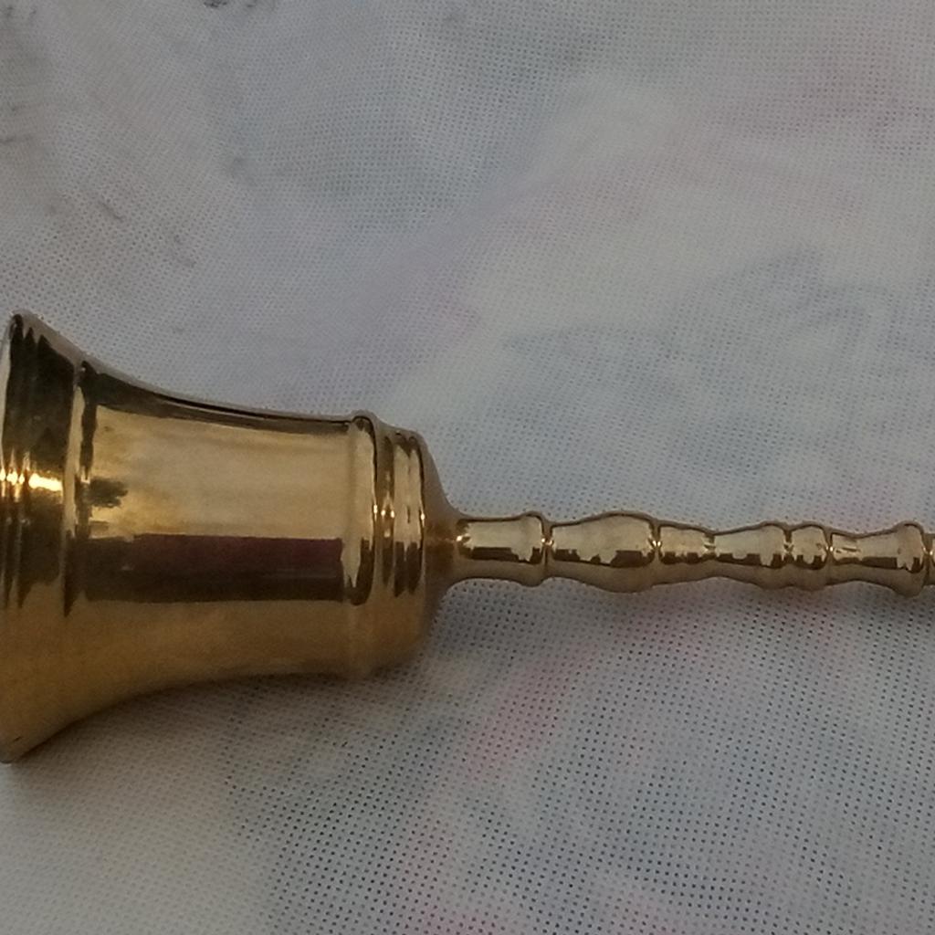 A wee bell with main body made of brass as well as the handle. Makes a very good sound that carries, as sadly can't post sound here.

H15.5W6.5cm

I used it it for my son when dinner was ready, as this gets through any phone, tablet, PC sounds to let him know. Daft things parents have to do in a generation growing glued to their devices, but this trick works.