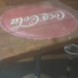 2half ft x 2half ft square table with a chrome base it's made of very good quality wood planks with the coca cola bottle top motif across the middle of the table I haven't seen any before so I have priced it accordingly as I have seen several different tables none of which are to this quality which are far more expensive