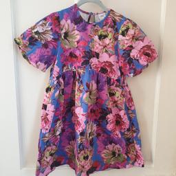 Gorgeous River Island Girl's Party Dress size; 9-10years. 
Bright Flowery short sleeved dress with black bow on the back. Cut out area between shoulders with a button at top.
Excellent condition, only worn once. 

Safe collection available or delivery can be arranged for a small charge
Shipped within 24hrs if using Royal Mail or Yodel.