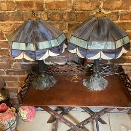 Vintage Pair Of Slag Glass Tiffany Style Lamps. 
These shades are very old and good quality. Thick original slag glass and very heavy. Beautifully handmade
Matching pair of shades with cast metal lily pad bases with finials on top. 
Beautiful pair of lamps, Sadly 1 shade has damage to 1 glass section as shown in the photos 
Viewing welcome