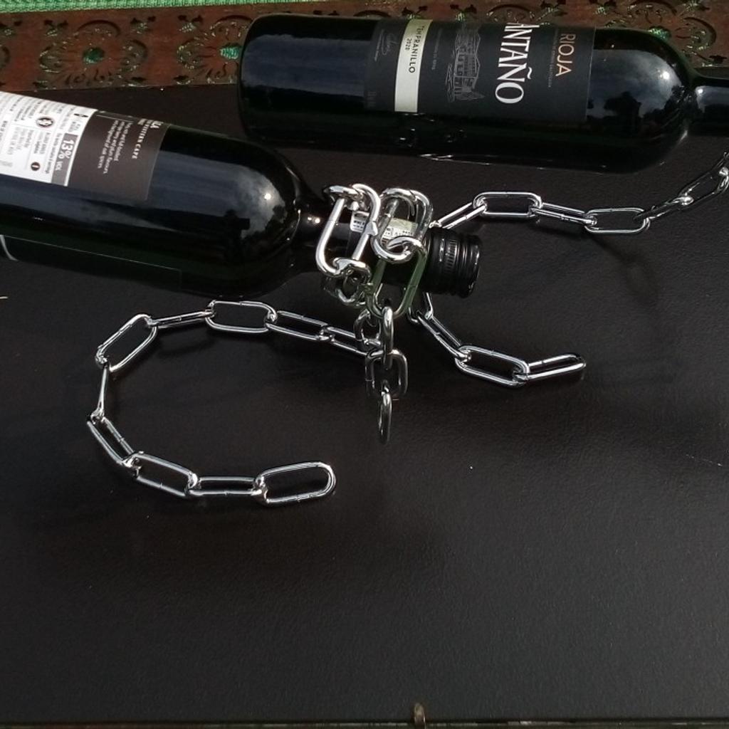 Chain mail wine bottle holder PAIR.

Definitely conversation piece to adorn any coffee table, man woman cave or kitchen. None alcoholic bottles can be used as this is simply a great art piece that's functional.