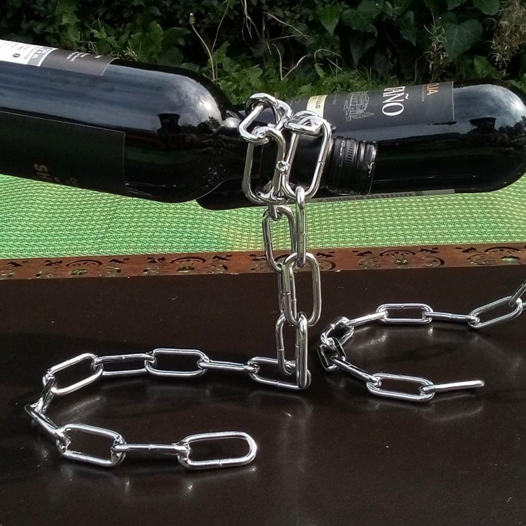 Chain mail wine bottle holder PAIR.

Definitely conversation piece to adorn any coffee table, man woman cave or kitchen. None alcoholic bottles can be used as this is simply a great art piece that's functional.