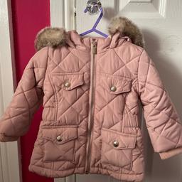 Lovely condition pink quilted coat with faux fur trimmed hood from River Island. Age 9-12 months