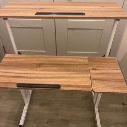Adjustable desk which can be used sitting and standing. Very comfortable and the height can be adjusted. It has wheels with safety stoppers. Quite easy to move around
