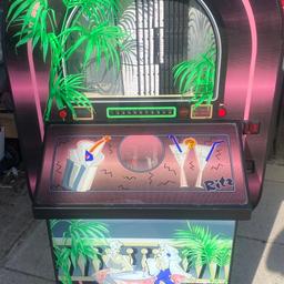 Sound Leisure CD Jukebox fitted with series 4 mechanism newly refurbished laser fitted set on FreePlay in full working order comes with mains lead door key and a free speaker to get you going on casters for easy movement very good condition any questions please ask cash on collection