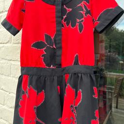 Red and black play suit with floral print and button front. Worn once