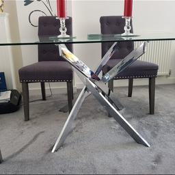 glass dining table with crossed chrome legs. 150cm x 90cm. height 75cm
Damage to one part of table shown in photos. Glass came apart and was glued back leaving glue marks.  can be covered easily and not to noticeable in person as its at the back of my table and no one notices it as a table plate matt covers it when being used.
NEED GONE ASAP

purchased for £290.

selling for £100 ONO

collect only.