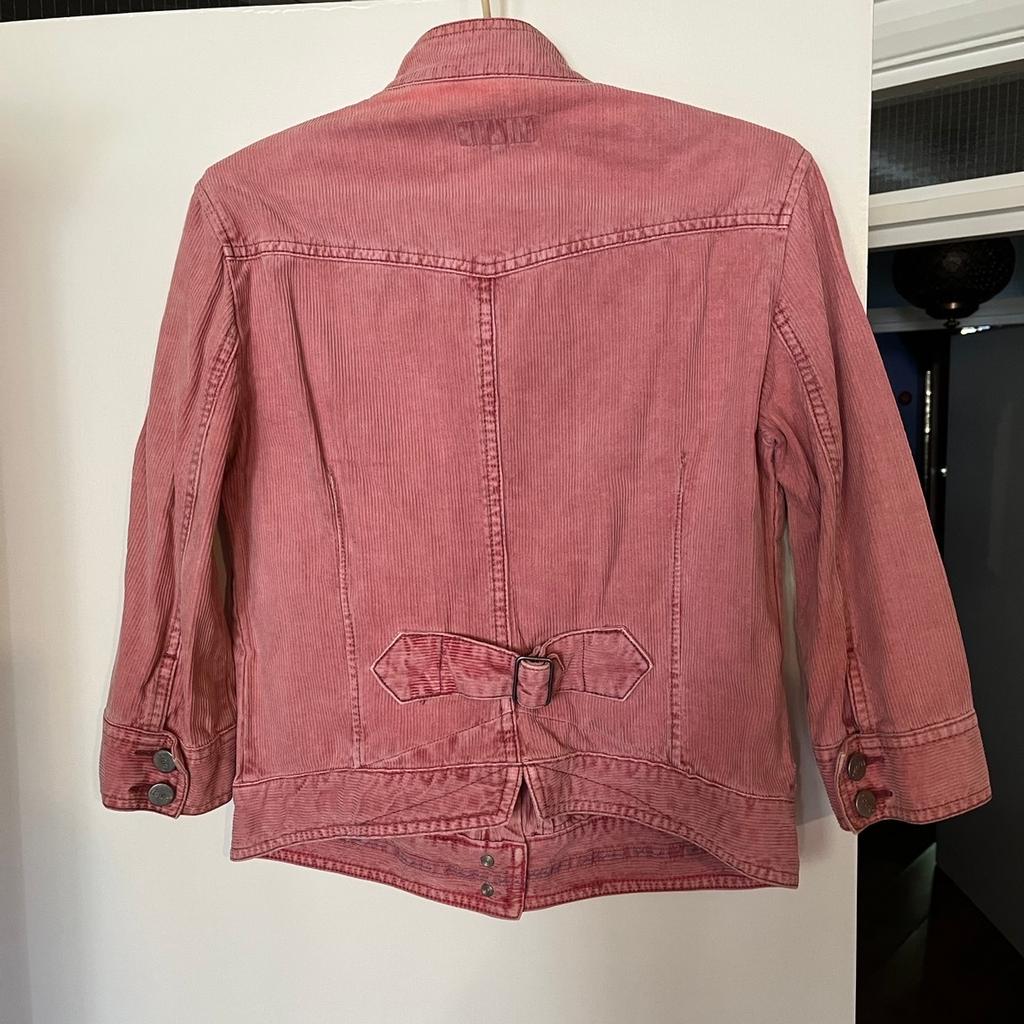 Pink corduroy bomber jacket with 3/4 length sleeves.