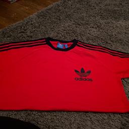 Men’s adidas T-shirt red with black logo and stripes. Never worn in excellent condition. Short sleeves
