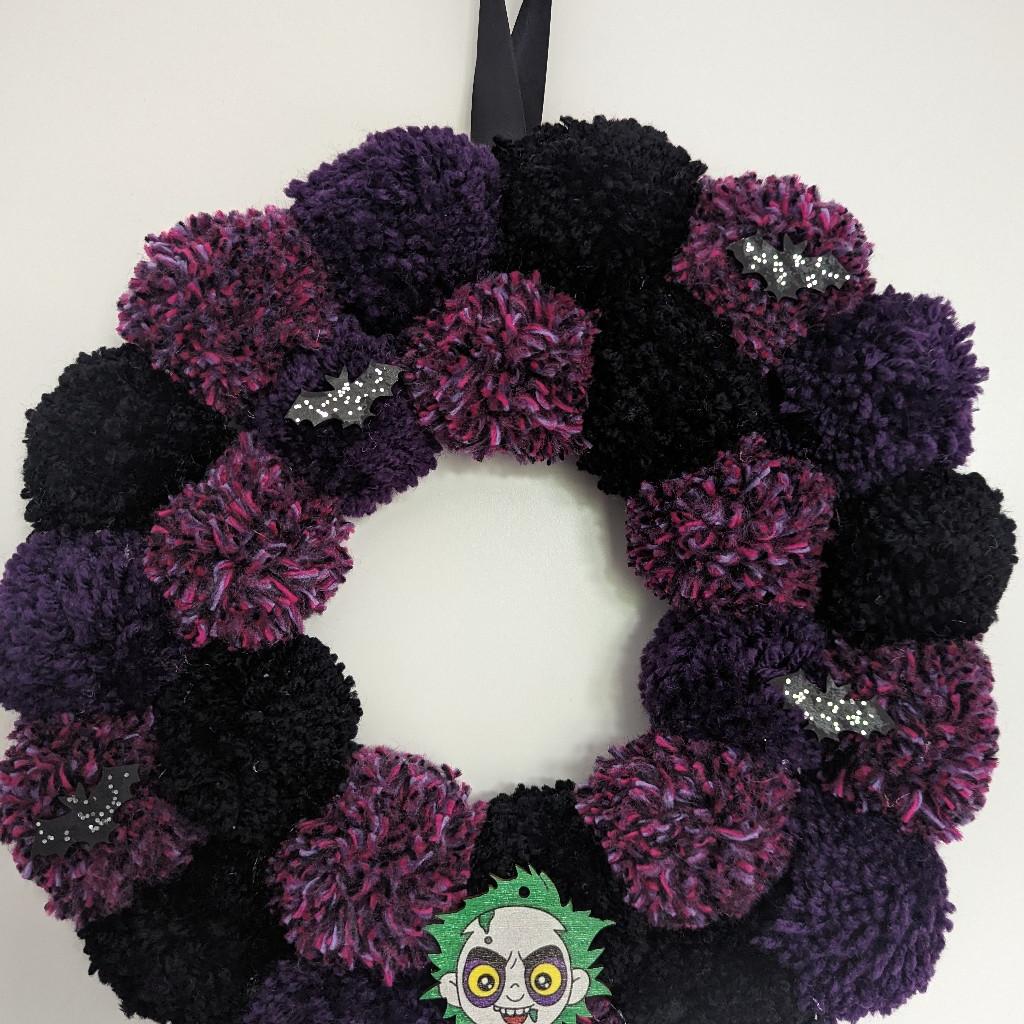 💜 Handmade Halloween Beetlejuice Wreath decor 💚 Deep purple, mixed purple and black pom poms with hand painted glittery bats, Beetlejuice embellishment and a black satin ribbon as hook 🖤 12x12 inches, £15
