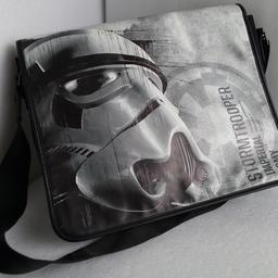This Star Wars Storm Trooper Messenger Bag is a must-have for any fan of the franchise. The bag features a printed image of the iconic Storm Trooper and is made of plastic. It has a shoulder strap for comfortable carrying and a magnetic closure for easy access to your belongings.

The medium-sized bag is perfect for casual occasions and has a black colour that goes well with any outfit. 

It has a fabric lining and adjustable strap for added convenience. This bag is perfect for everyday use.
