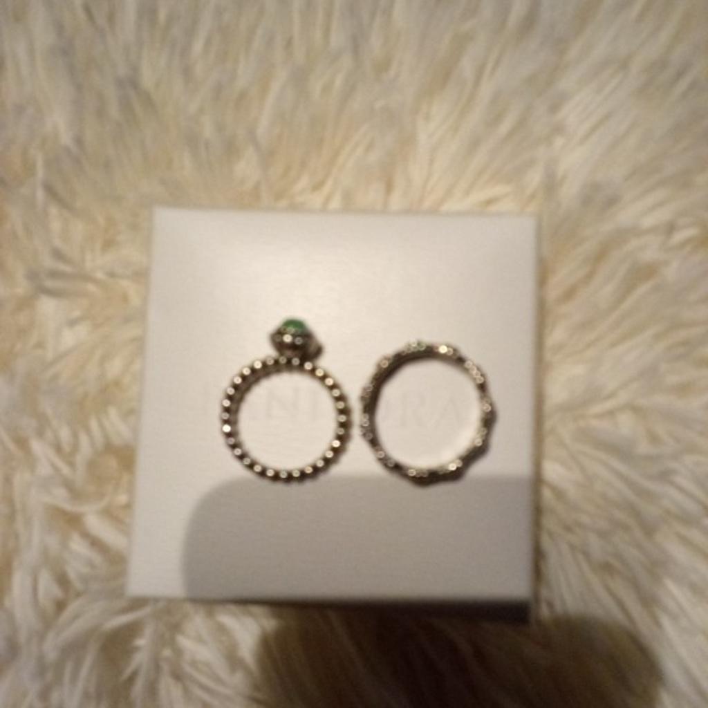 Two Pandora rings.Green May birthstone one is size 54 £10. the second ring has pink coloured stones around, is a size 58 and £15. both have Pandora boxes, and have ale and size inside.both for £20