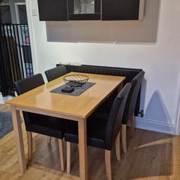 wooden dining table 
with 4 faux leather black chairs 
only used for few months but moving house and cannot take it with me. 
one small chip on table as seen on photograph. 
chairs have no marks or scratches.