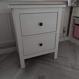 Bedside table/chest of drawers (HEMNES Chest of 2 drawers, white stain, 54x66 cm) bought four years ago now for sell due to bedroom renovation. The bedside table is in very good condition with no damaging signs and comes with a glass top worth £20. We are selling it at less than half price of you can buy in store. The bedside table comes fully erected. Picture of same bedside table sold in the shop shown on the images.