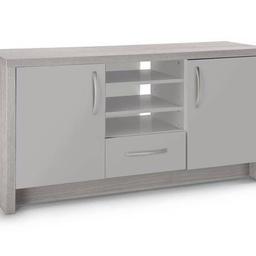 Venice 2 Door 1 Drawer Low Sideboard - Grey fully assembled but all new was £175 and now £110 and we can deliver local 
this sideboard doubles up as a TV unit. It can be used to simply de-clutter your living space or it can accommodate TVs up to 50 inches in size. There's a mix of storage space (including adjustable shelving, cupboards and a drawer) so you can choose what you want out and what to tuck out of sight
Size H 63, W 117, D40cm.
Chrome coloured handles.
1 drawer with metal runners.
2 doors.