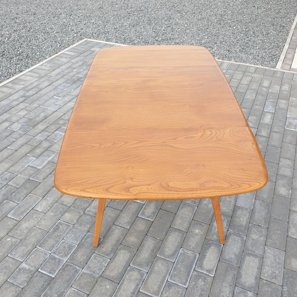 A lovely blonde Ercol Windsor drop leaf dining table having the early blue label and in good condition. Possible delivery at a cost depending where you are.