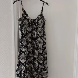 black layered flowered dress with adjustable straps. lined with support top