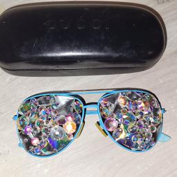 Snazzy sunglasses with swarovski/precioso crystal covered lenses. No name frames. In a Gucci case but NOT Gucci. You won't see much through these crystal sunglasses but you will certainly be seen! UNIQUE!