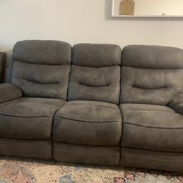 Almost brand new leather coach with reclining chairs and charger port inside the sofa comes in a set of 4