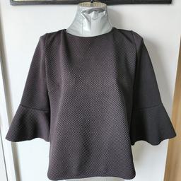Zara Black Waffle Top with Fluted Sleeves. Size M. Has rounded side hems. Great condition.
