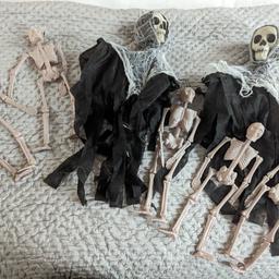 Halloween figures, two hanging skeletons with fringed cobweb cloak, and no legs and 5 plastic skeleton hanging figures. All in good condition and from pet and smoke free home