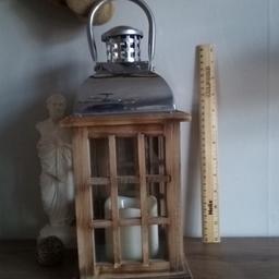 Large Wooden Candle Lantern  for Home Garden Patio or simply indoors.  This has a electronic candle, which works with battery included.

Material made from , Glass Windows with Stainless Steel Top, with real wooden enclosure.

Height: 48 cm Width: 20 cm Depth: 20 cm.

Collection preferred or can be posted out for extra costs.