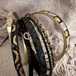 Set of 6 metal bracelets.really pretty in black and gold.with mirror pieces glitter and charms on them.lovely quality from Next Been £8.00