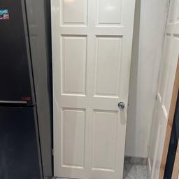 White standard size wooden door still has handle and hinges on it must b able to collect selling cheap due to not needing it
