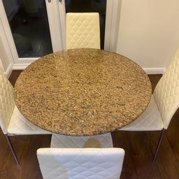Granite round dinning table with soiled stainless steel leg very heavy bought from John Lewis with 4 faux cream leather chairs can be sold separately. Two chairs have a couple of marks on the seat £400 Ono