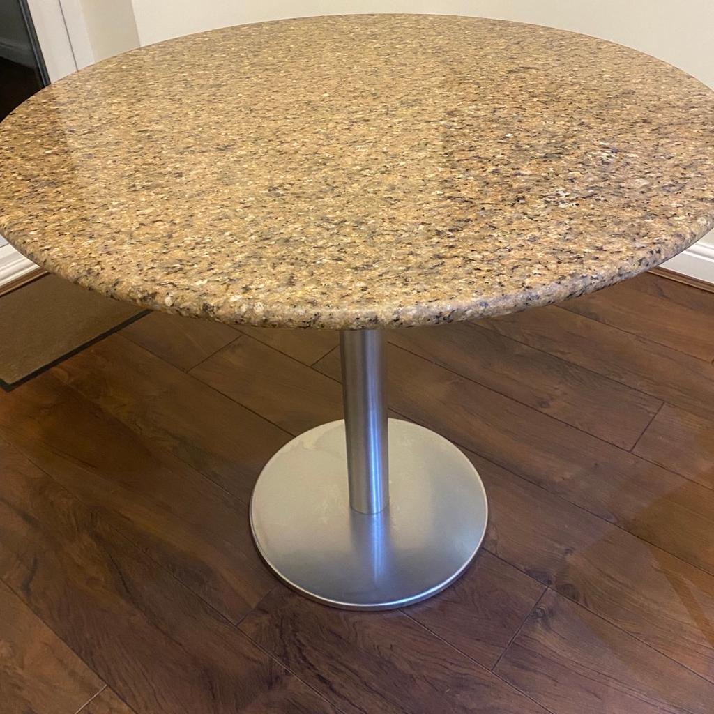 Granite round dinning table with soiled stainless steel leg very heavy bought from John Lewis. Chairs not included pick up only