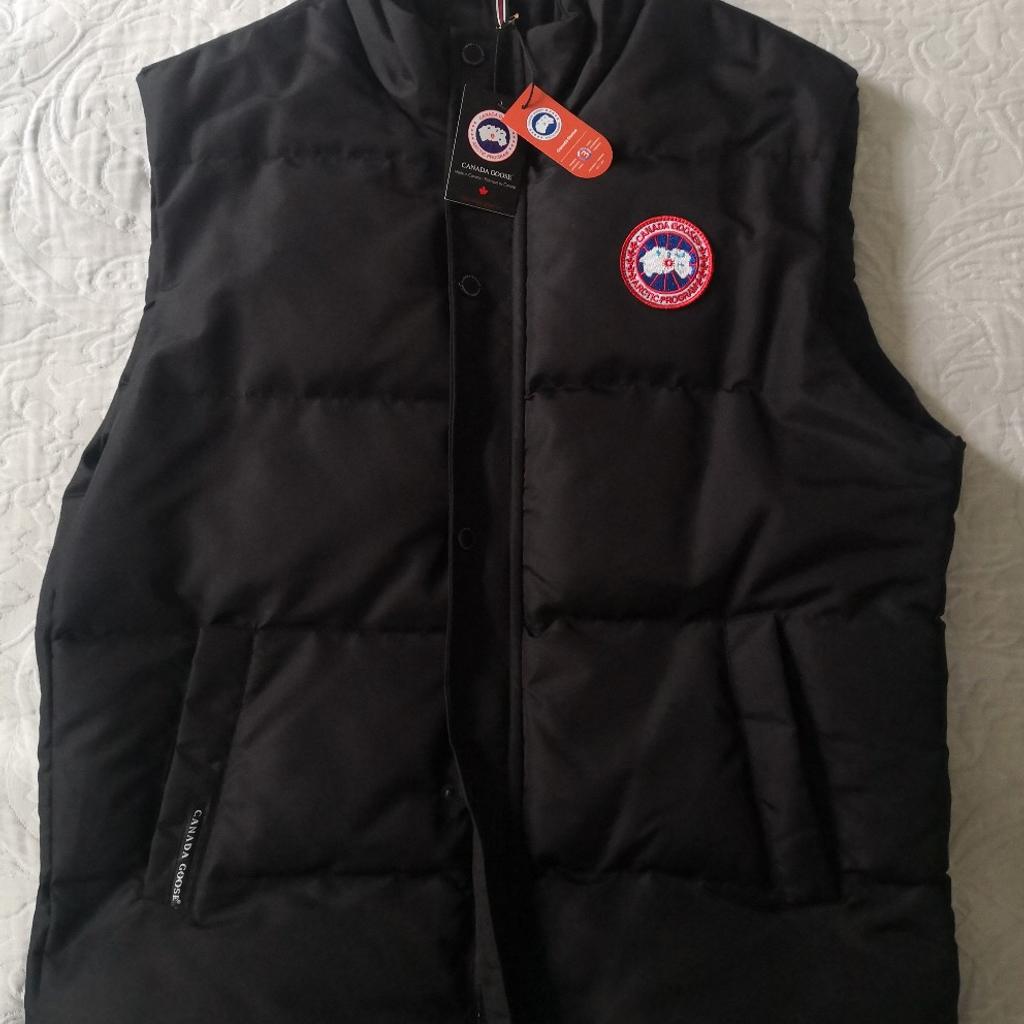 Canada Goose Gilet. XXL. Brand new with tags. Black, quilted, 2 side pockets, 1 large zipped inside pocket. Canada Goose logo on each zip and press studs. Extremely warm and excellent quality. Unwanted present, cash needed for new car. Collection preferred, as too valuable for posting and buyer must try on for size and satisfaction. However, I'm prepared to post via insured, tracked and signed for postage at extra cost of £20. Must sell, hence asking such a low bargain price of £225, which is significantly lower than the true value of this item!