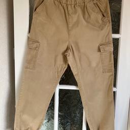 H&M Cargo Trousers size 12.  Tan colour.  Pull on.  Elasticated waist.  Two hip side pockets and two Utility pockets on sides.  Elasticated hems.  Few marks as in pics and worn but plenty of wear left.