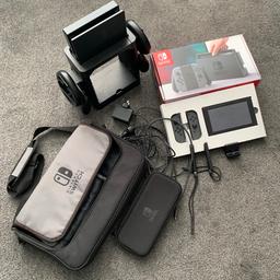 Re-listed due to time waster! 
This is an original grey Nintendo Switch console in original box with all contents and additional extras, messenger bag with console case, in car charger, hdmi cable, tower where docking station fits to the top, steering wheels & controller adapters to the sides with drawer and games storage. Small stand, see pictures for all items included.

In used, working, condition reset to factory settings.

Selling only as no longer played with by our boys.

No games included.

Pick up from OL9/North Chadderton area of Oldham.

SOLD AS SEEN. Buyer to be happy with bundle before leaving with it.

Do not waste your, or my time, with silly offers, you will be ignored 🤷‍♀️

Any questions please ask 🙂