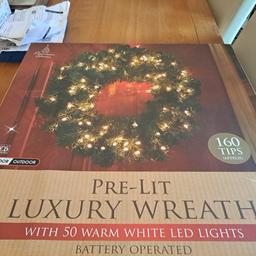 new in box pre lit luxury wreath uses 3xAA batteries not included has 50 warm white led lights that can be static or flashing.indoor and outdoor use.from smoke and pet free home